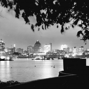 Vancouver's skyline by night as seen from Stanley Park across Burrard Inlet in 1961.  credit: Vancouver Archives