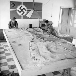 Canadian soldiers study a German plan of the beach during D-Day landing operations in Normandy on June 6, 1944.   c/o Library a